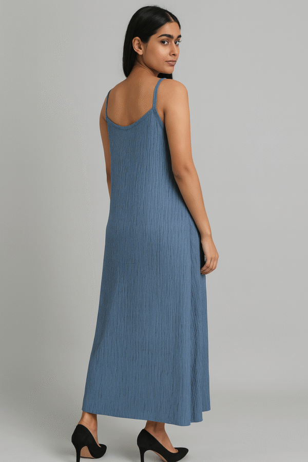 Woman wearing a textured blue spaghetti strap maxi dress