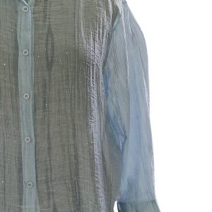 Close-up of bead embellishments on blue textured shirt