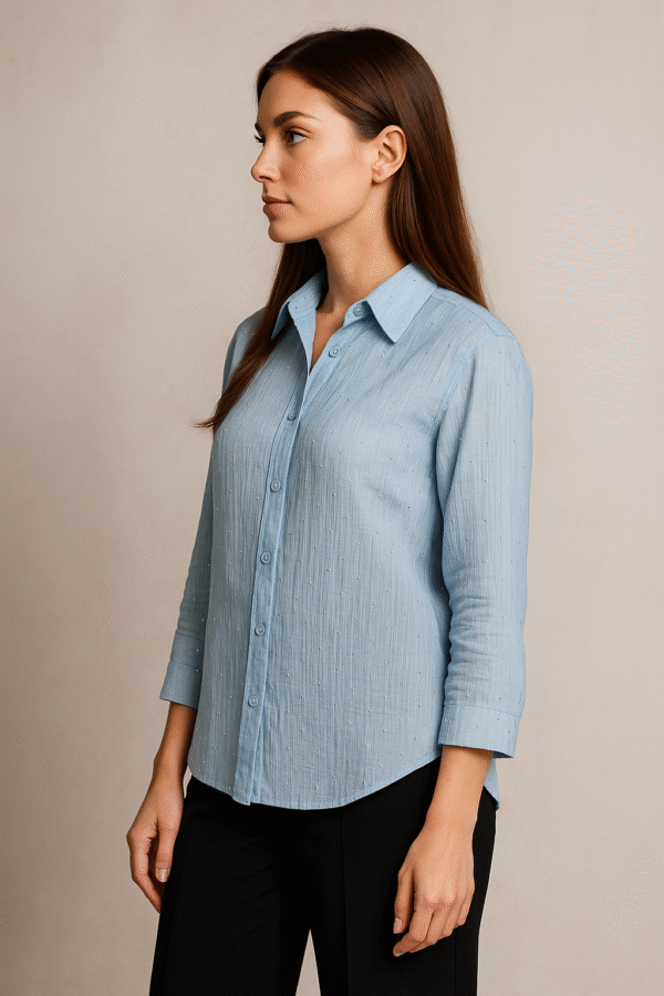 Model wearing Azure Grace Beaded Shirt with navy trousers