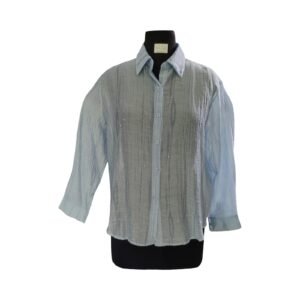 Close-up of bead embellishments on blue textured shirt