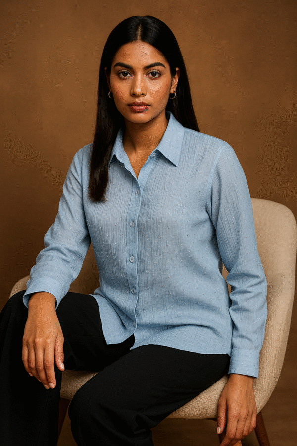 Model wearing Azure Grace Beaded Shirt with navy trousers