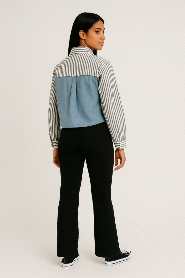 Woman in striped and denim-paneled shirt