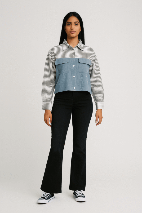 Woman in striped and denim-paneled shirt