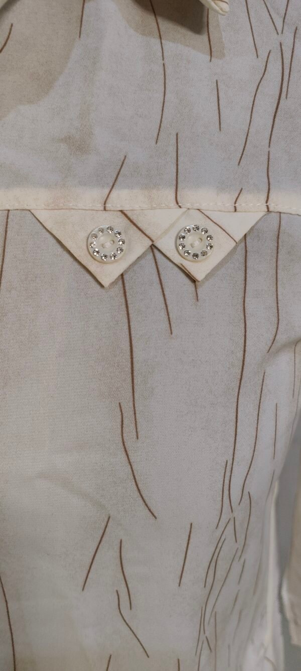 Close-up of textured beige button-up shirt with subtle stripe detailing