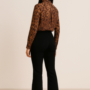 Model wearing elegant amber-brown animal print shirt with full sleeves and black tailored trousers