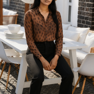 Model wearing elegant amber-brown animal print shirt with full sleeves and black tailored trousers