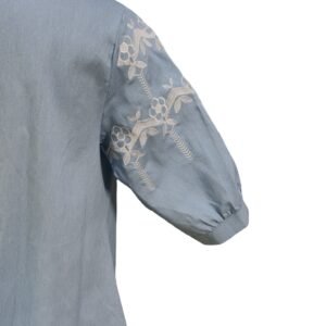 Woman wearing powder blue embroidered cotton denim shirt with mandarin collar