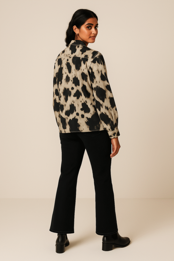 Woman wearing abstract marble print shirt with black jeans