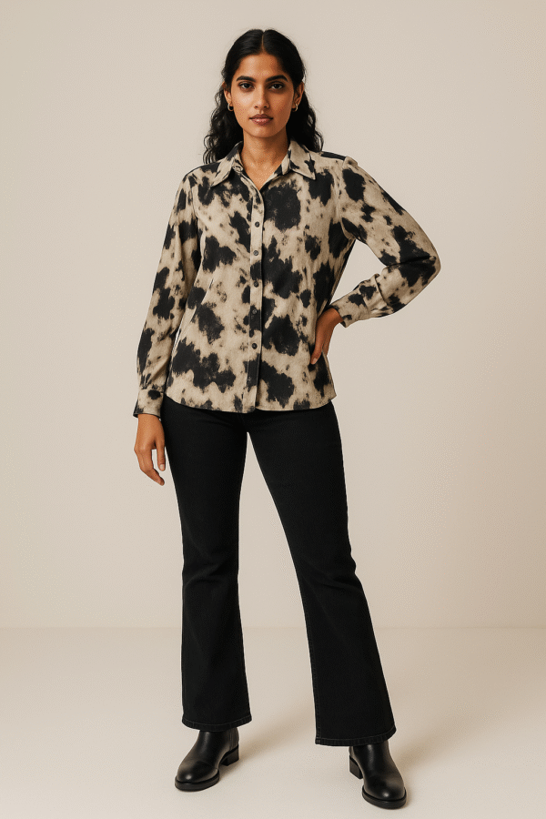 Woman wearing abstract marble print shirt with black jeans