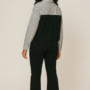 Striped and solid black combo shirt styled with black pants and sneakers for bold casual look