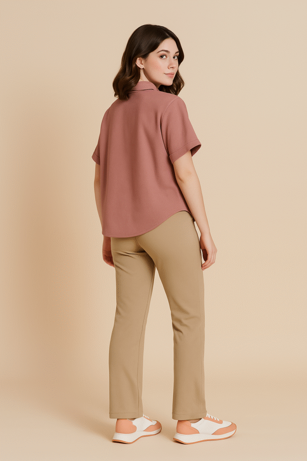Young woman wearing a mauve short-sleeved shirt with heart embroidery and contrast pocket