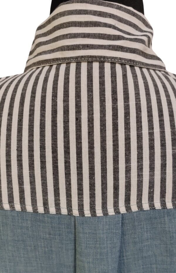 Woman in striped and denim-paneled shirt