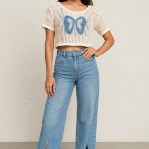 Model wearing net crop top with denim bow paired with high-waist jeans and sneakers