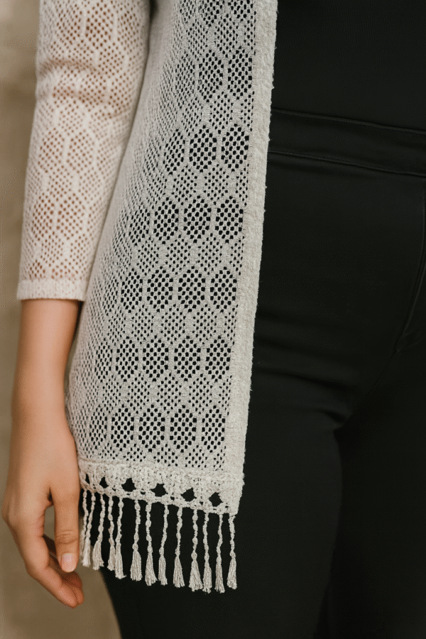 model wearing white crochet shrug with black outfit