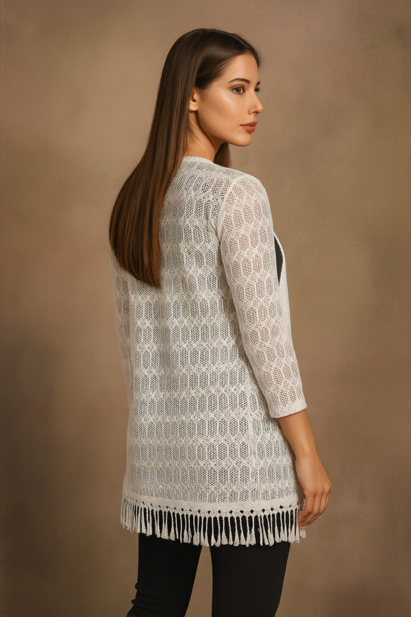 model wearing white crochet shrug with black outfit