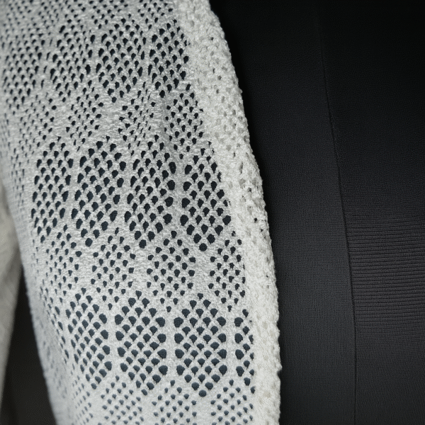model wearing white crochet shrug with black outfit