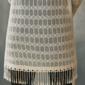 model wearing white crochet shrug with black outfit
