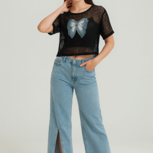 Model wearing black net top with spaghetti inner paired with blue jeans
