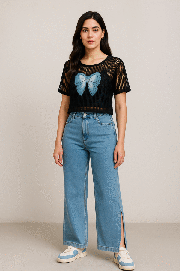 Model wearing black net top with spaghetti inner paired with blue jeans