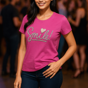 Smiling woman in magenta t-shirt with “Smile!” in crystal studs and pearl heart