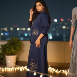 Two-piece navy co-ord outfit featuring shirt and A-line skirt with blooms