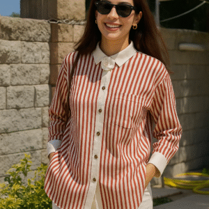 Model wearing red and ivory striped shirt with floral brooch