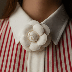 Model wearing red and ivory striped shirt with floral brooch